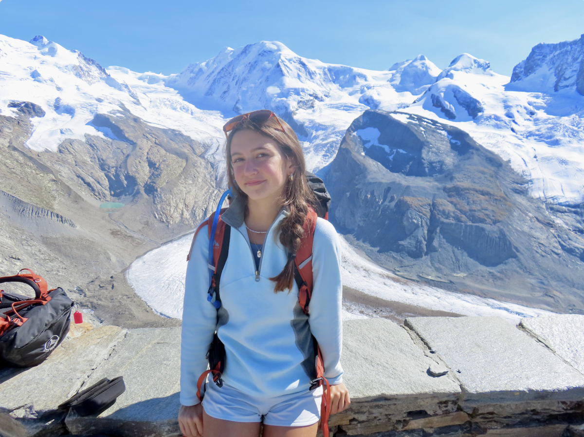 Scarlett Harper stands in front of Gorner Glacier in the Monte Rosa massif, near Zermatt, Switzerland, which has experienced significant melting in the past few years